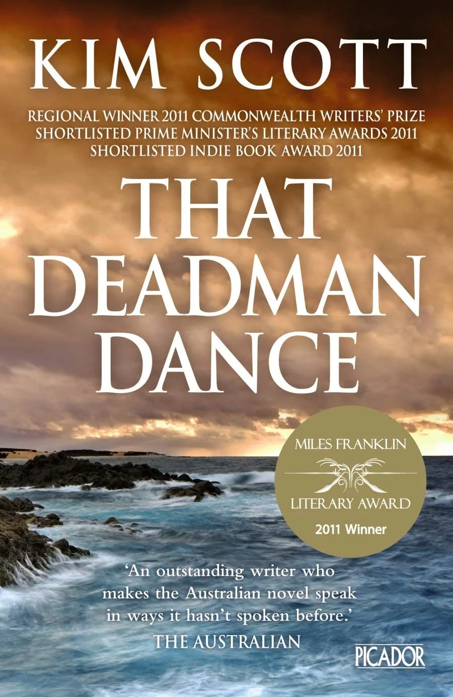 Book cover of That Deadman Dance by Kim Scott. A rough sea and a cloudy orange sky.