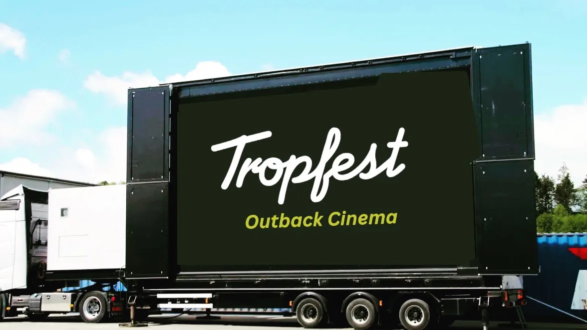 Image showing a truck with a screen on a trailer with the words "Tropfest Outback Cinema".