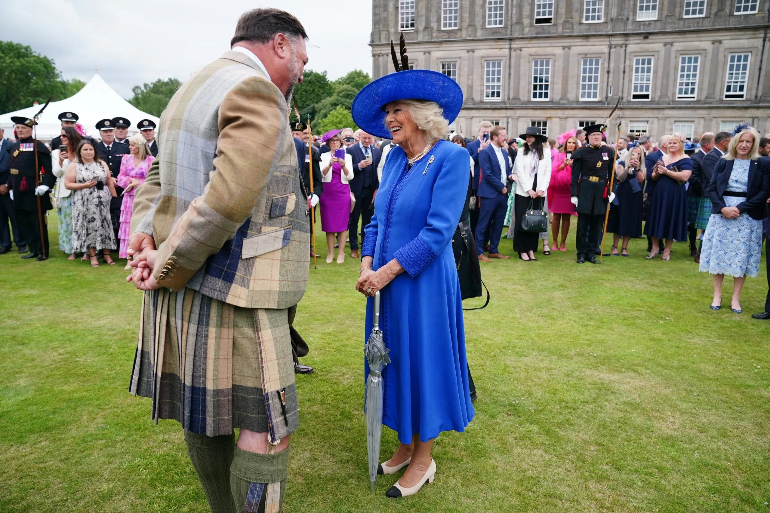 EDINBURGH, SCOTLAND - JULY 01: Queen Camilla speaks with Campbell Archibald from Kirriemuir, Perthshire, during the Sovereign's Garden Party at the Palace of Holyroodhouse on July 1, 2025 in Edinburgh, Scotland. King Charles III and Queen Camilla are visiting Scotland with members of the Royal Family for a Royal Week until Friday, July 04. (Photo by Jane Barlow - WPA Pool/Getty Images)
