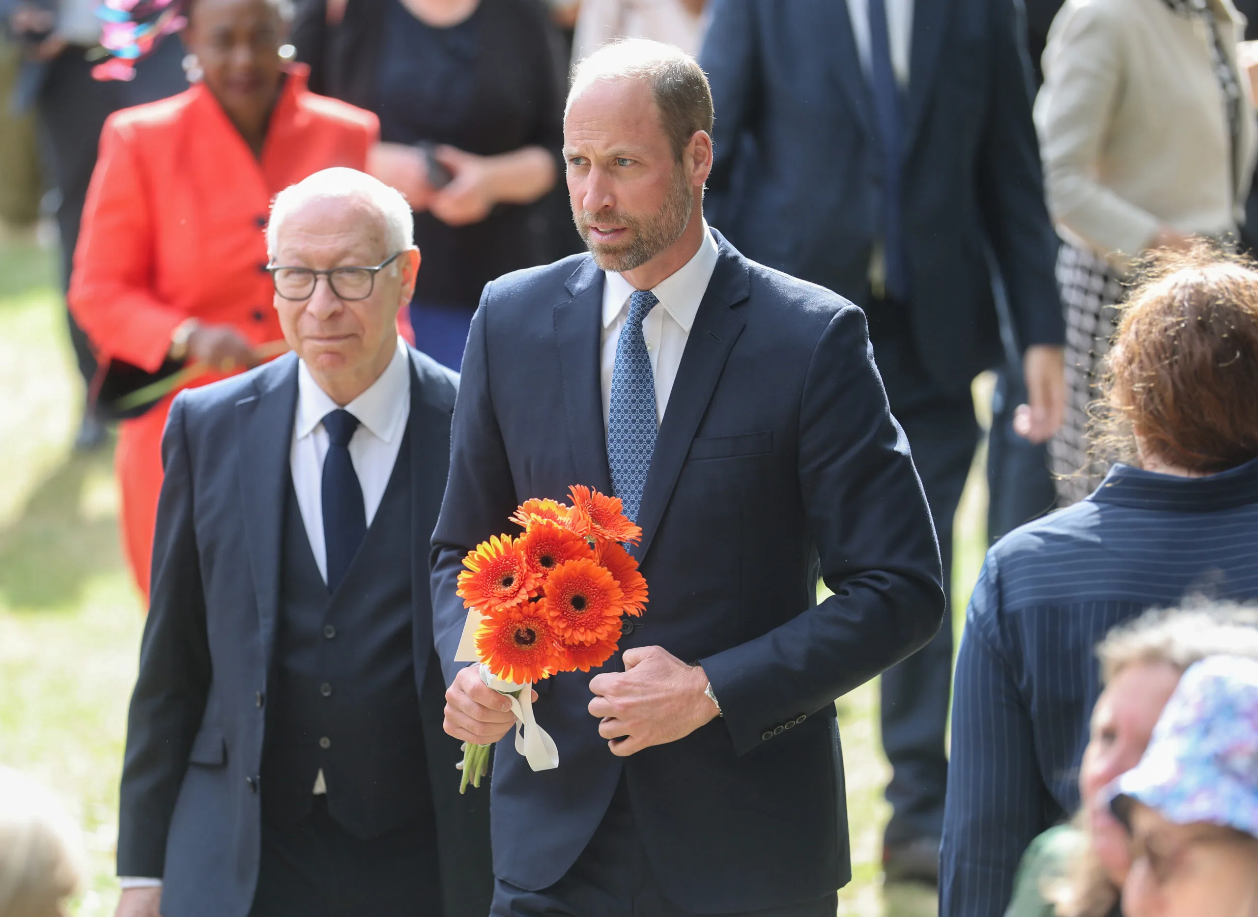 LONDON, ENGLAND - JULY 07: Prince William, Prince of Wales holds a bouquet of flowers as he attends a memorial service for the 20th Anniversary of the 7th of July 2005 bombings at Memorial Gardens at Hyde Park on July 07, 2025 in London, England. Prince William, Prince of Wales joined survivors of attacks and family members of the victims for the service. (Photo by Chris Jackson/Getty Images)