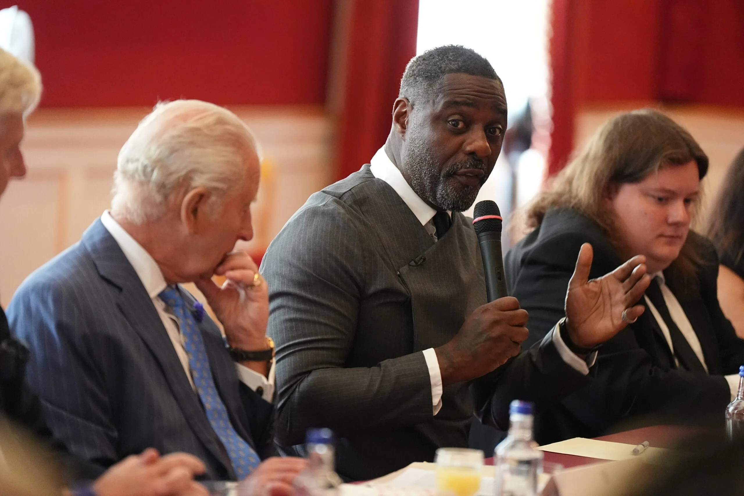 LONDON, ENGLAND - JULY 15: King Charles III listens as Idris Elba, founder of the Elba Hope Foundation and an alumnus of the King's Trust, speaks during a Youth Opportunity Summit with young people, youth organisations, government officials, and representatives from the sports, education and arts sectors at St James's Palace on July 15, 2025 in London, England. (Photo by Aaron Chown - WPA Pool/Getty Images)
