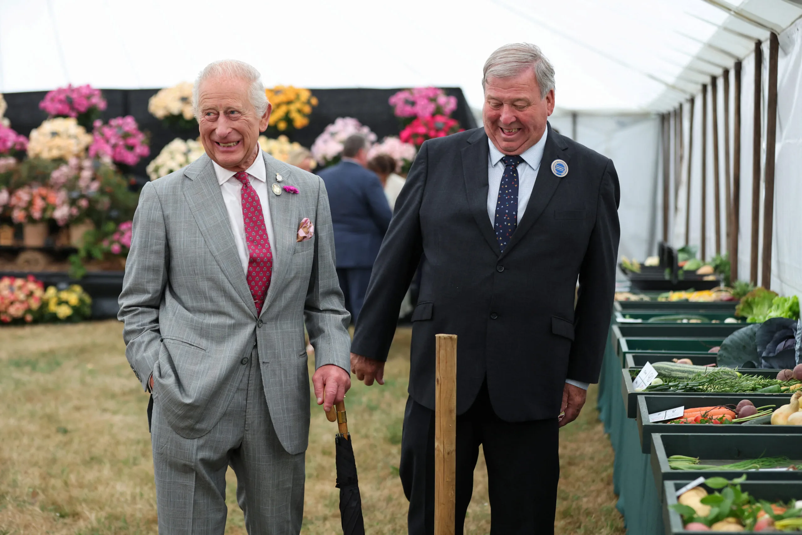 KING'S LYNN, ENGLAND - JULY 23: Graham Browne, the chairman of the Sandringham Flower Show accompanies King Charles III as he visits the Sandringham Flower Show 2025 at Sandringham House on July 23, 2025 in King's Lynn, England. (Photo by Chris Radburn - WPA Pool/Getty Images)