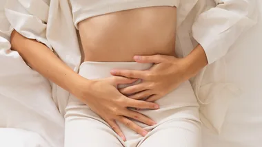 Woman touching stomach