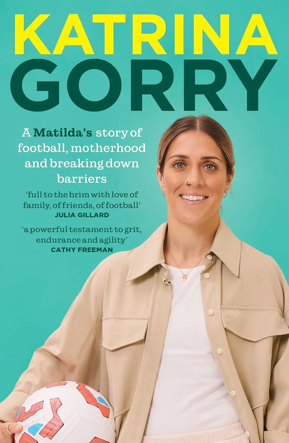 Book cover Katrina Gorry. Photo of soccer player Katrina Gorry holding a soccerball on a green background.