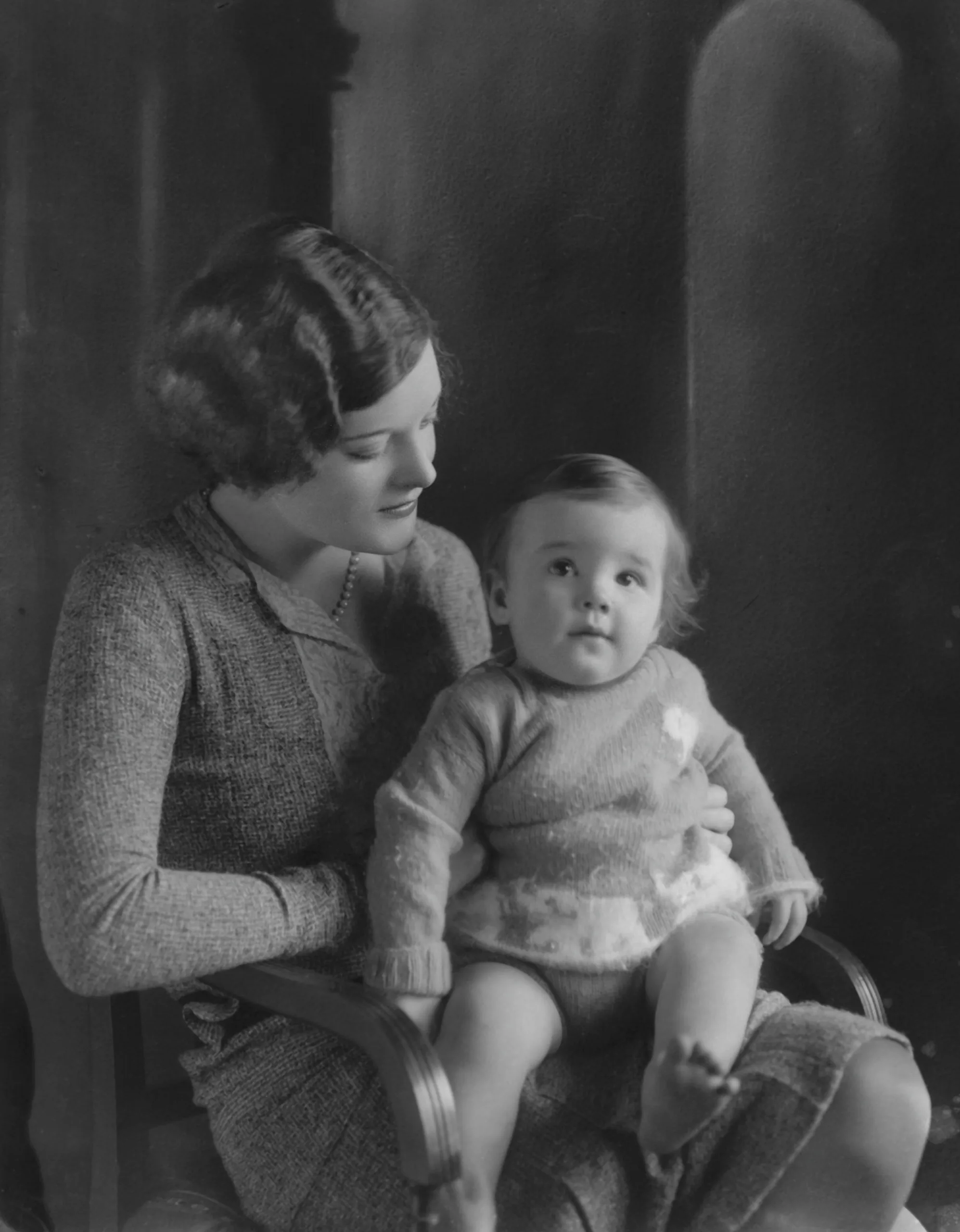 Australia's forgotten duchess Nell with her son, Sidney. Photo of a woman holding a young boy in her lap.