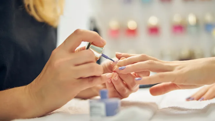 Woman getting nails done at salon