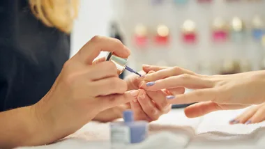 Woman getting nails done at salon