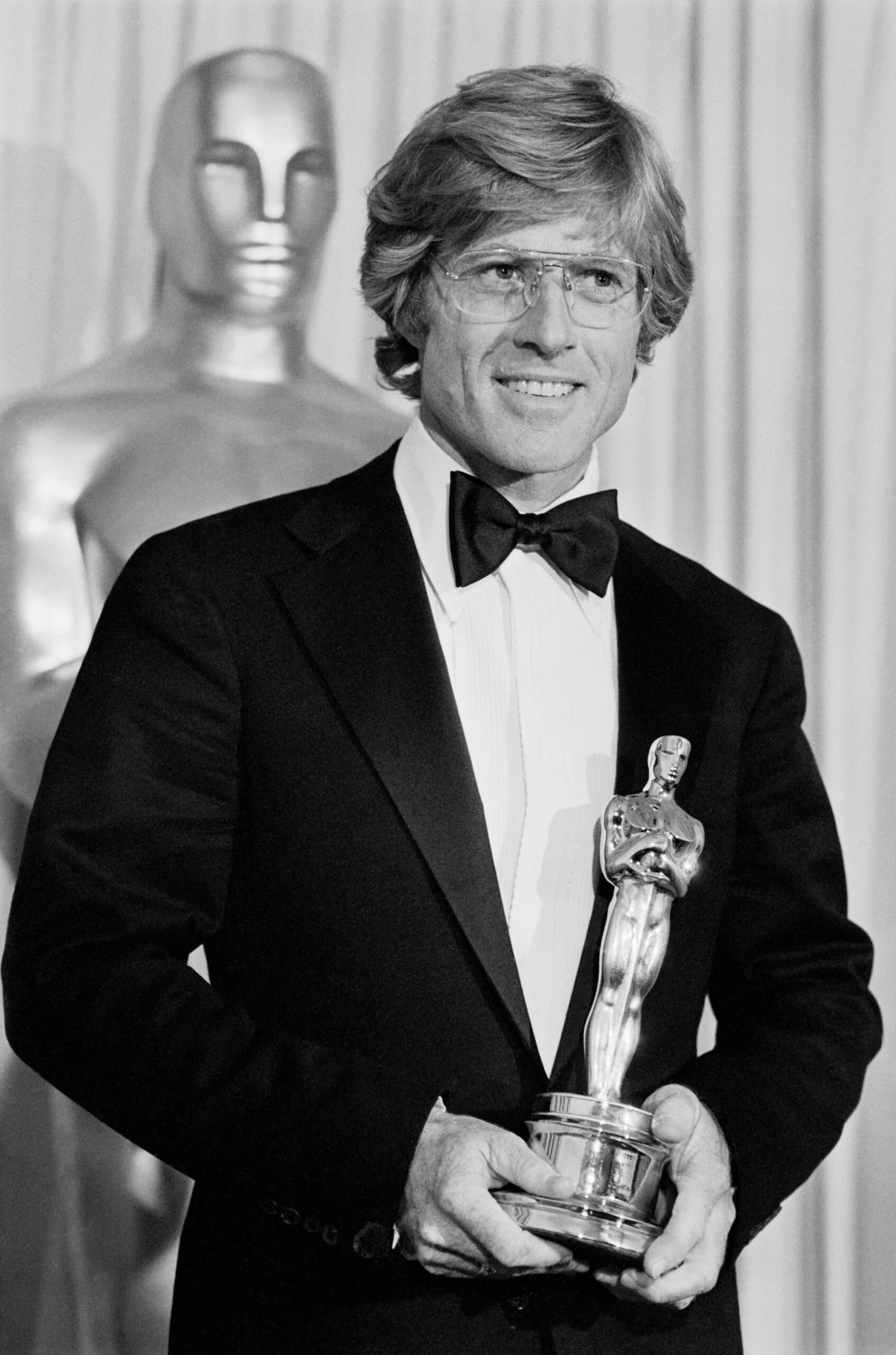 (Original Caption) 4/1/1981-Hollywood, CA-: Robert Redford admires his Oscar after he won it for Best Achievement for Directing in the movie, Ordinary People. The Oscar was one of the two top awards won by the film, the second being the Best Picture award.