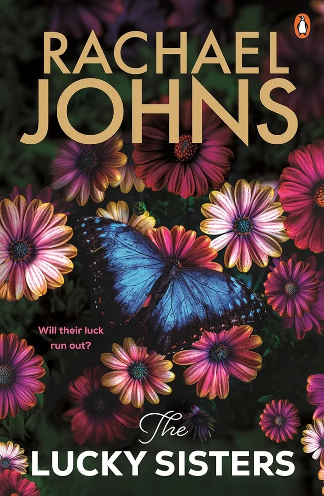 Rachael Johns the lucky sisters book cover. A blue butterfly sits on a bed of pink flowers