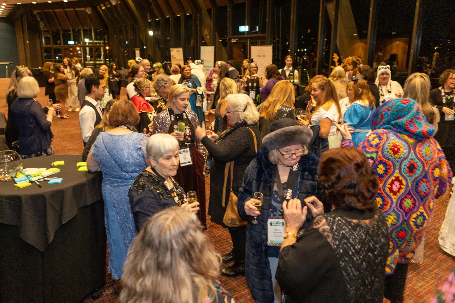A group of people gathering indoors at the romance writers of Australia conference
