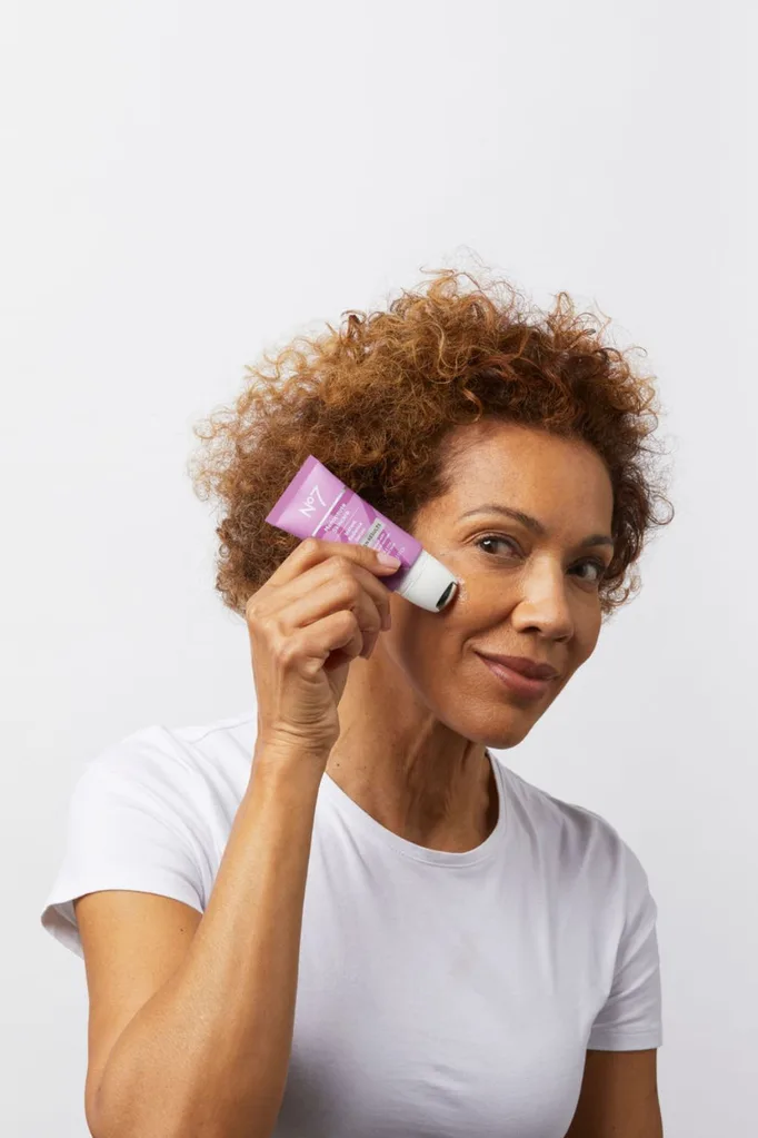 Women applying no7 menopause skincare serum