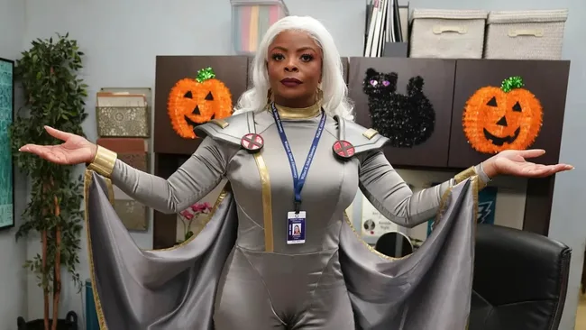 A black woman dressed as Storm from X-men. Abbott Elementary, Candy Zombies Halloween episode still.