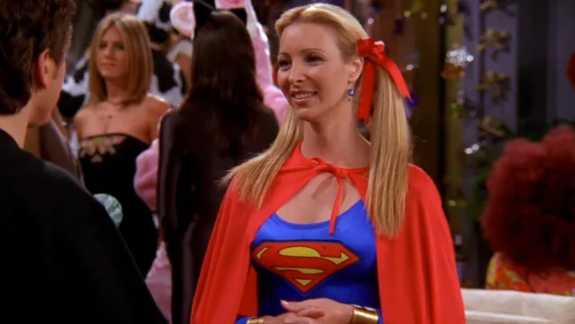 Still from TV show Friends' Halloween episode. Phoebe wears a supergirl costume.