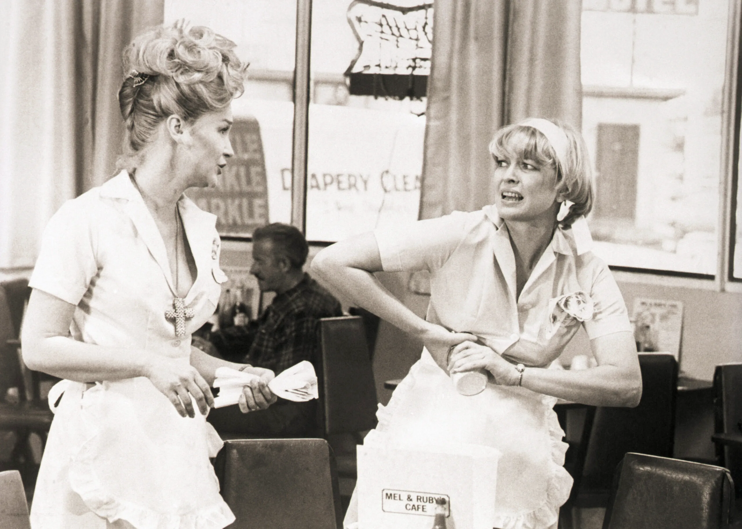 (Original Caption) 9/1974- Actress Diane Ladd (left) and Ellen Burstyn in a scene from the movie Alice Doesn't Live Here Anymore. Burstyn is shown trying to open a jar as Ladd sets a table in a diner.