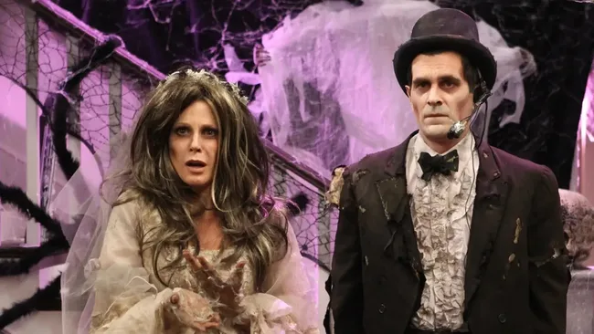 Still image from Modern Family TV episode Halloween. A man and woman dressed in creepy bride and groom outfits.