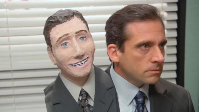 The Office tv halloween episode still. Michael (Steve Carrell) holds a manequin of himself.