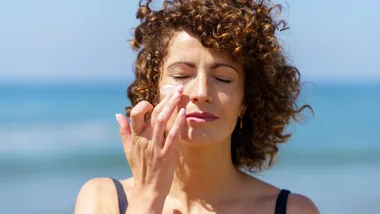 Woman applying sunscreen