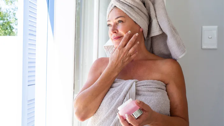 Woman applying skincare
