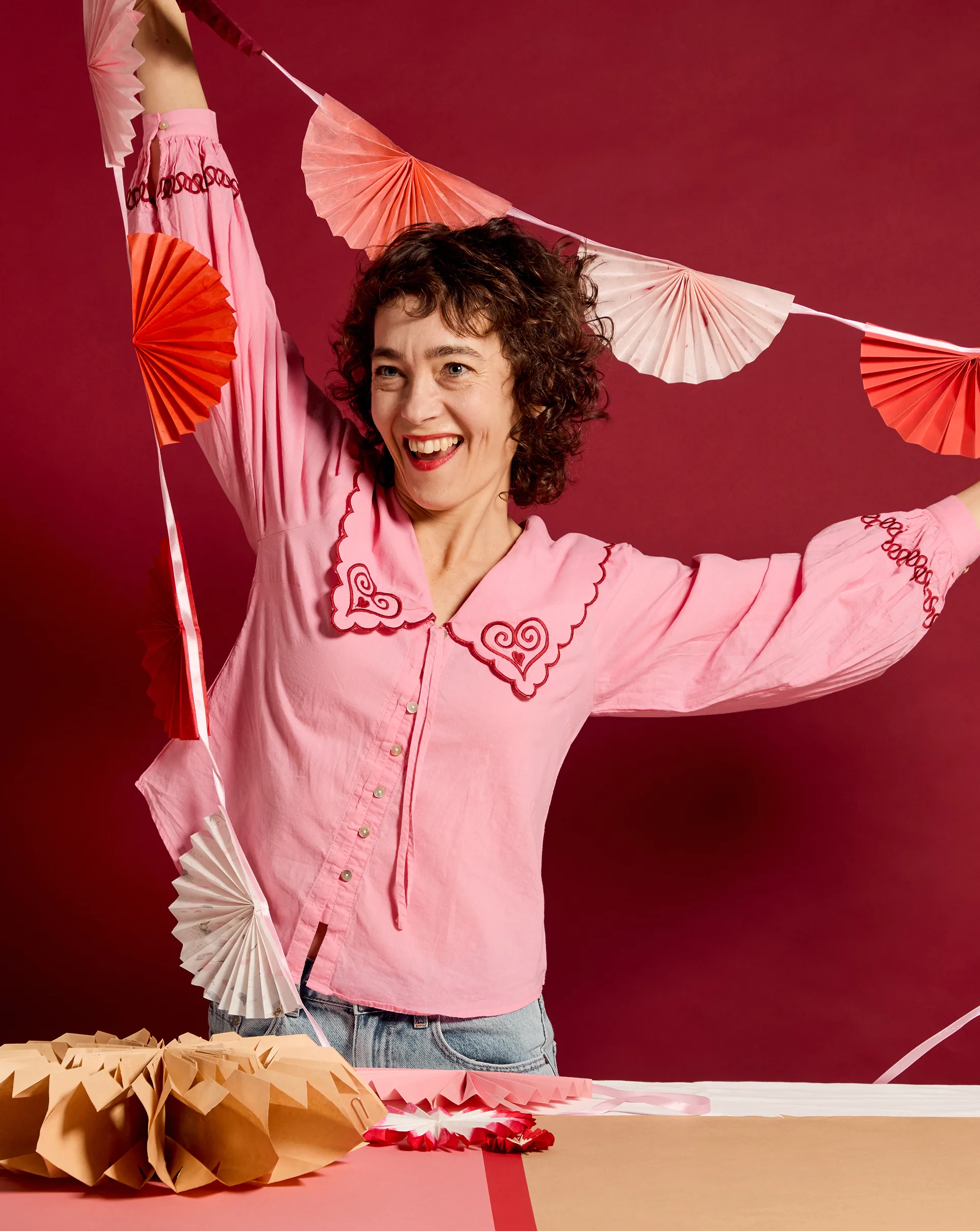 Susie Rugg with her paper fan garland. Photography by Lauren Trompp