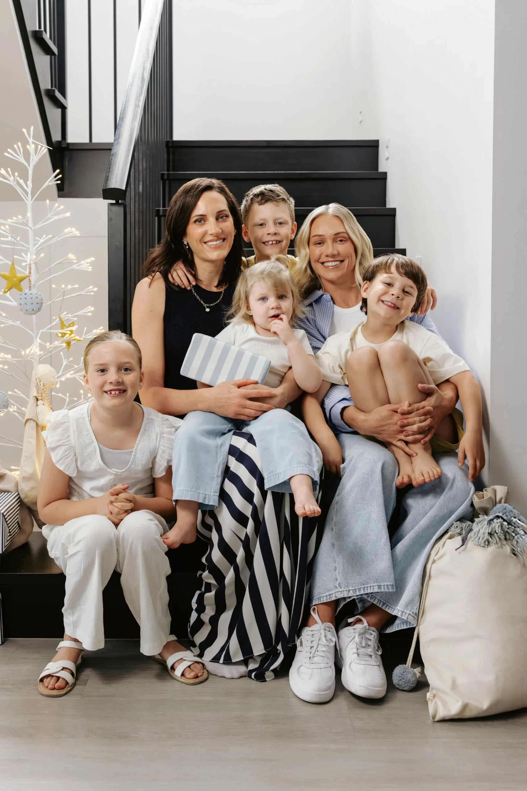 Erin Phillips and her family sitting on steps. Photography by Christopher Morrison