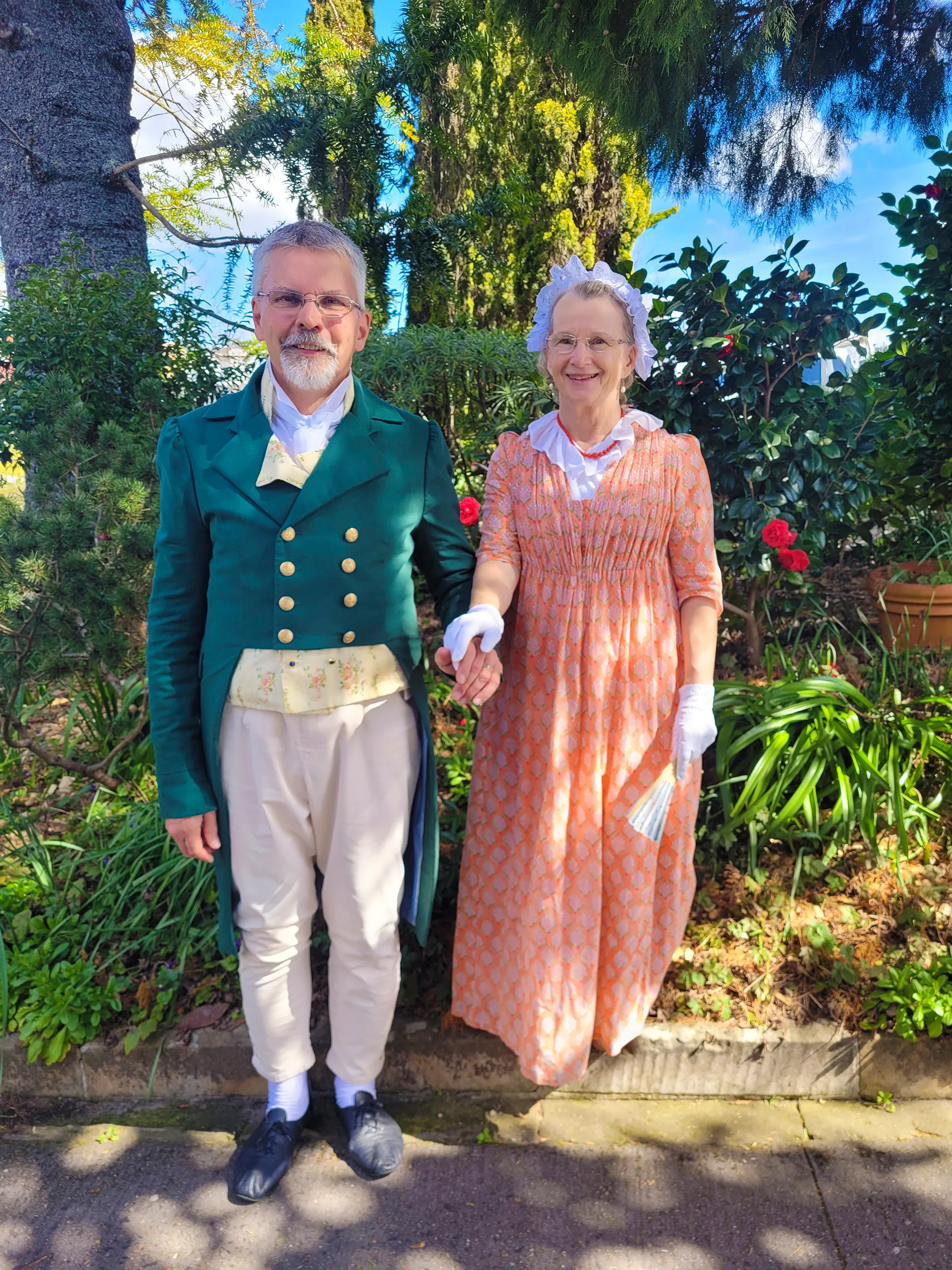 Two Jane Austen fans, a man and a woman, celebrate her legacy in historical dress.