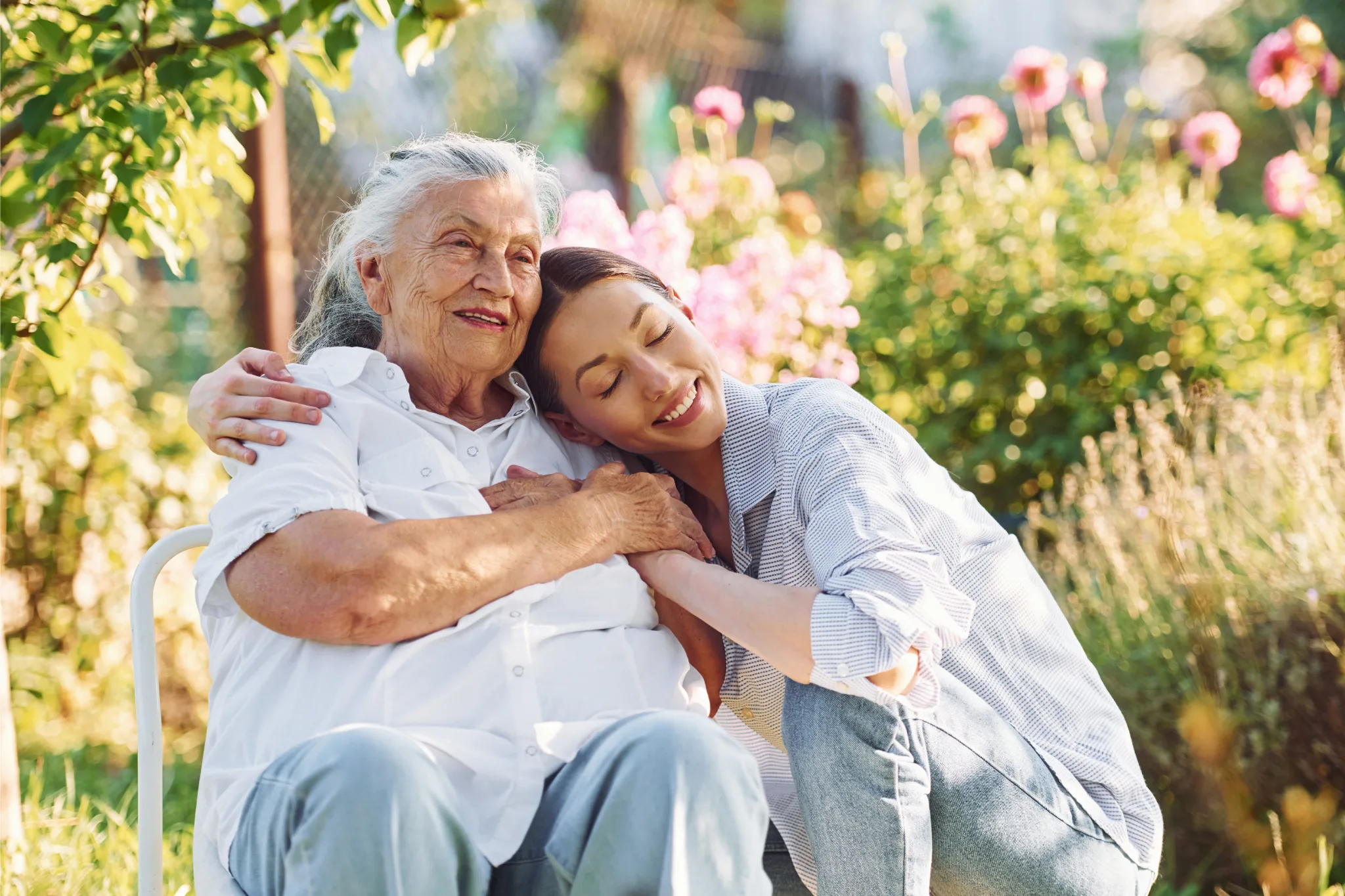 women needing aged care hugging younger woman