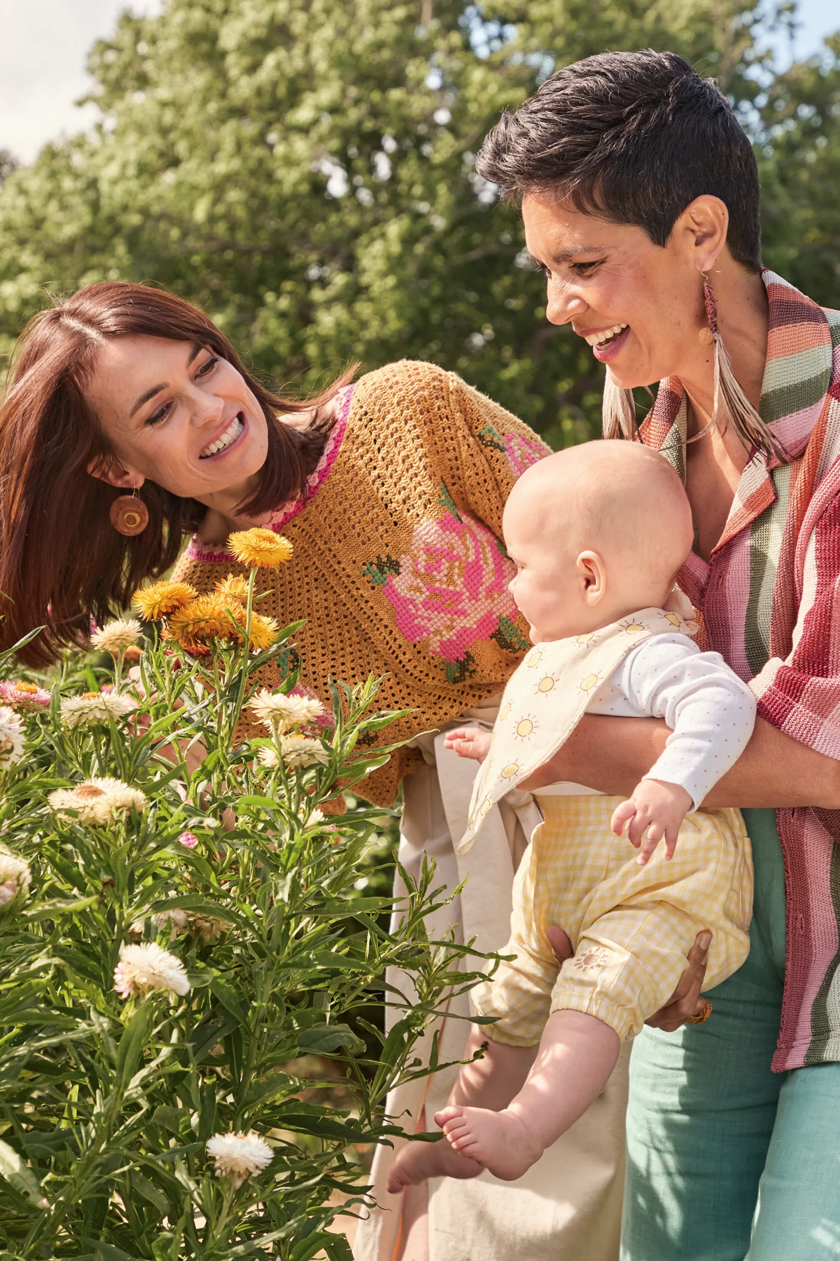 Narelda Jacobs, Karina Natt and baby Sanna playing with flowers. Photography by Lauren Trompp