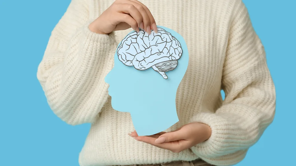 torso with hands held in front holding a paper shape of a head