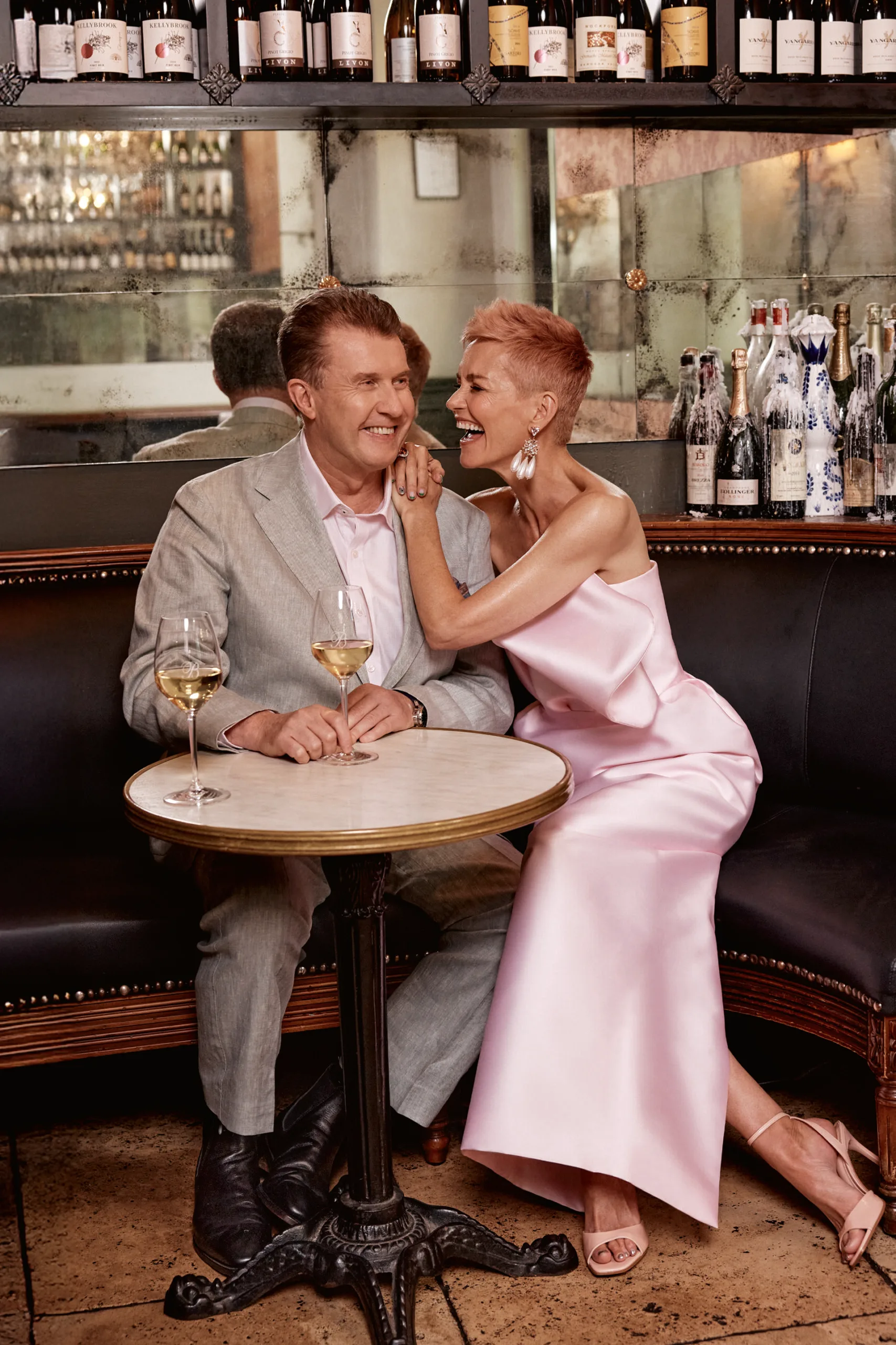 Peter Overton and Jessica Rowe sitting having a glass of wine. Photography by Corrie Bond.