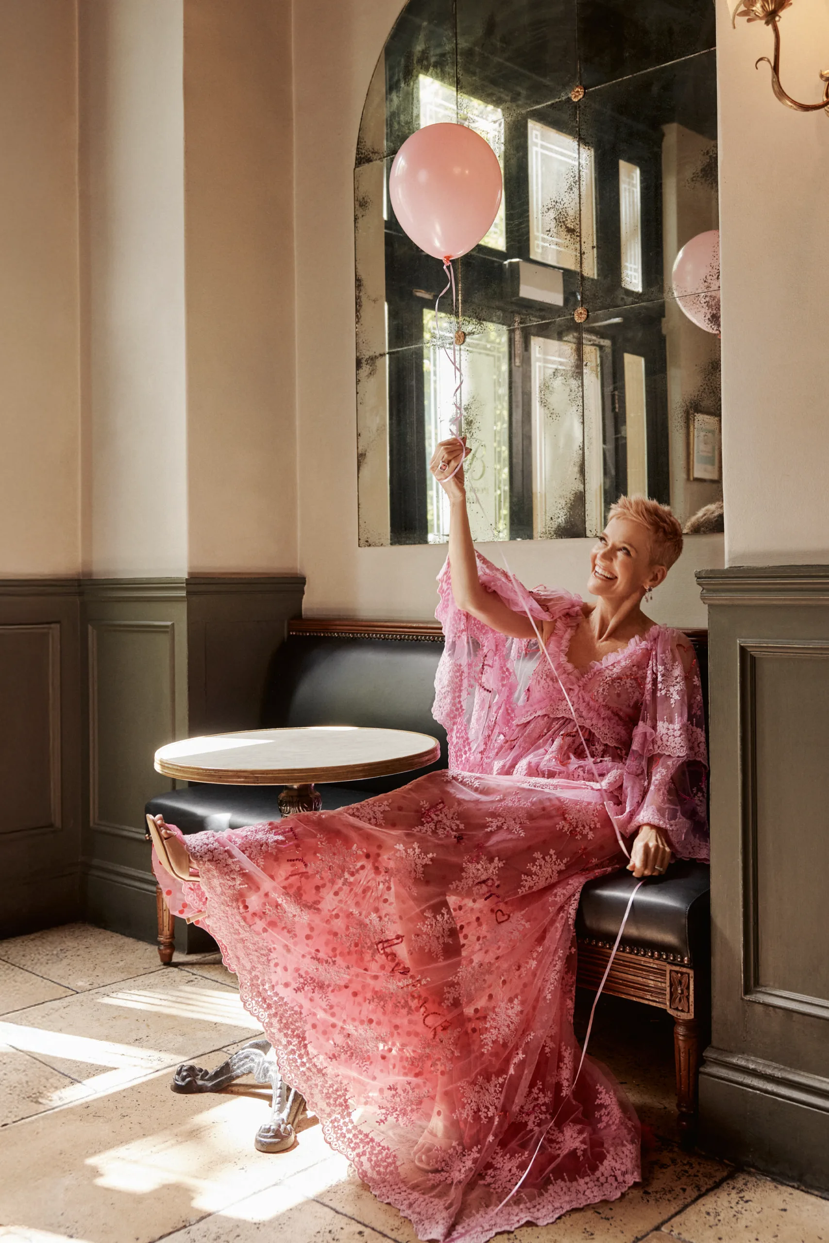 Jessica Rowe holding a balloon and kicking up her leg. Photography by Corrie Bond.