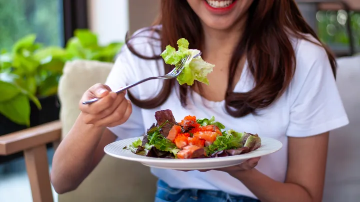 Woman eating salad