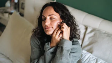 Woman massaging face