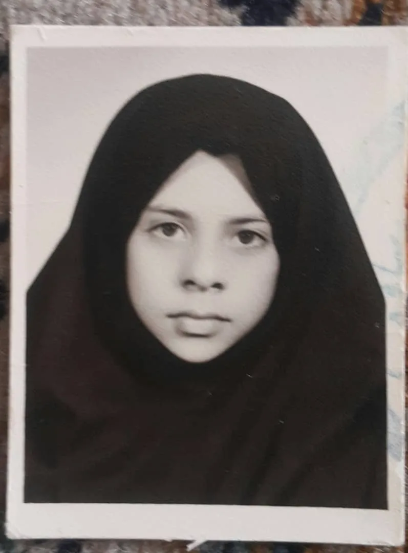 Saba as a young child wearing a black hijab.