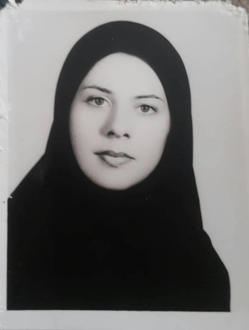 Saba as a young woman wearing a black hijab.