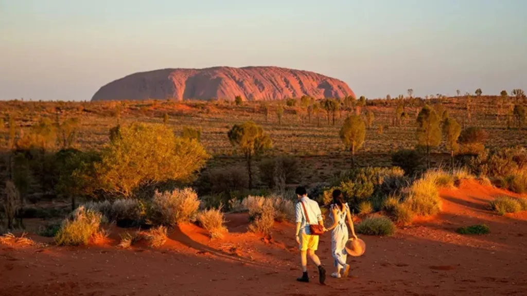 couple exploring Uluru in northern territory small group tour