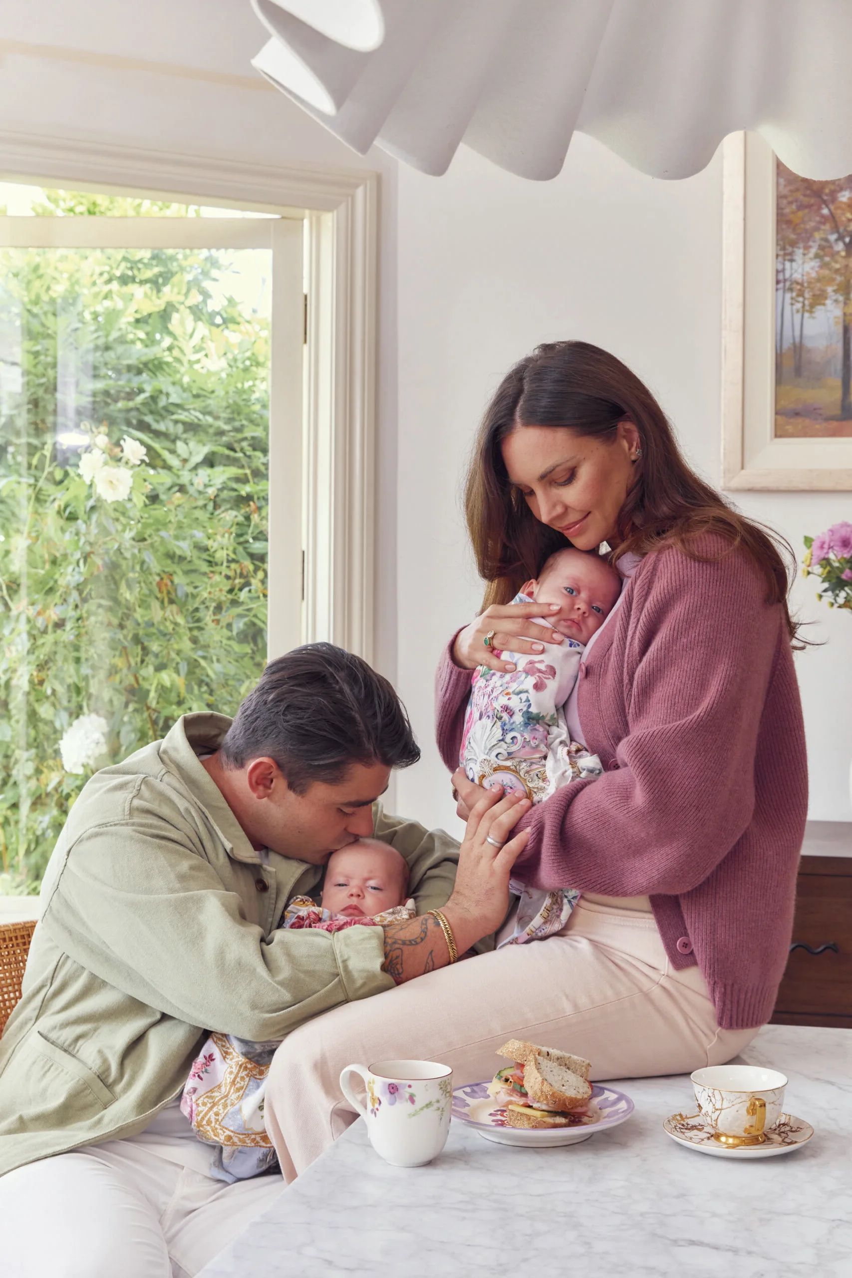 Sarah Todd, Declan Cleary and their twin daughters sitting at the kitchen bench. Photography by Alana Landsberry.