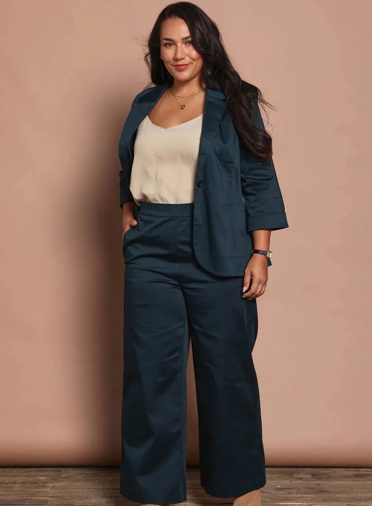 A model wearing the Birdsnest Belle Cotton Comfort Wide Leg Pants in deep teal with a coordinating blazer, styled with a neutral top and gold necklace.