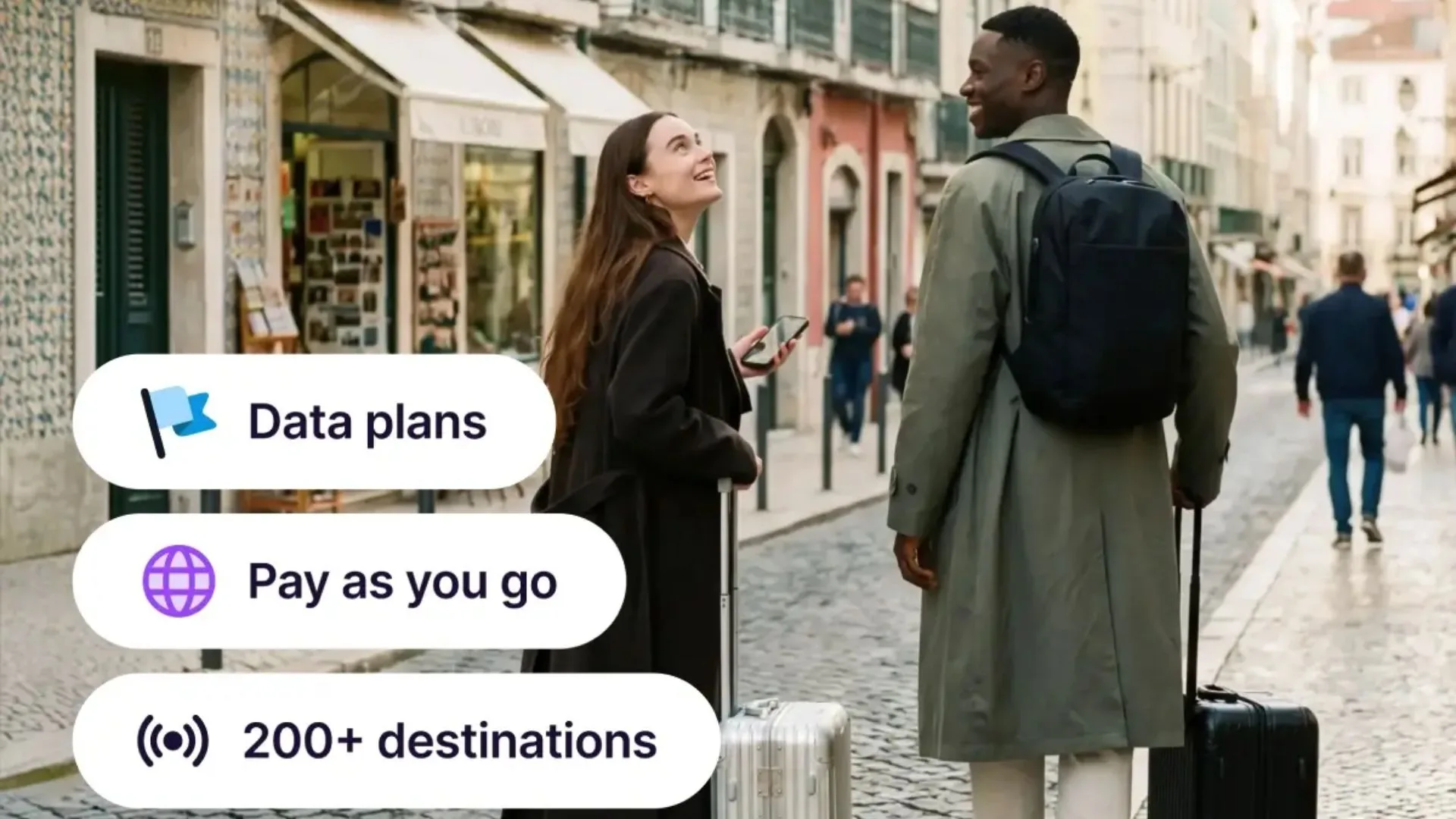Two travellers with suitcases walking down a European city street, overlaid with text bubbles highlighting Roamless features: "Data plans", "Pay as you go", and "200+ destinations".