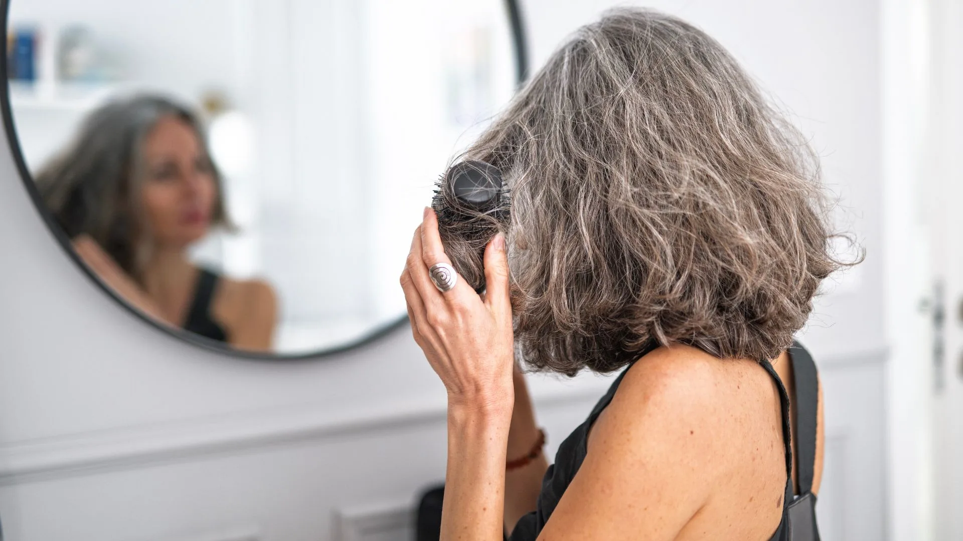 woman blow drying her hair