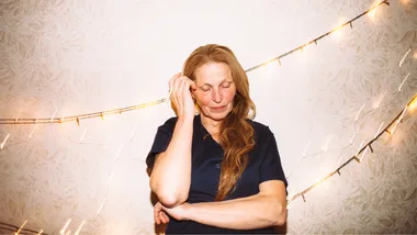 older woman touching hair