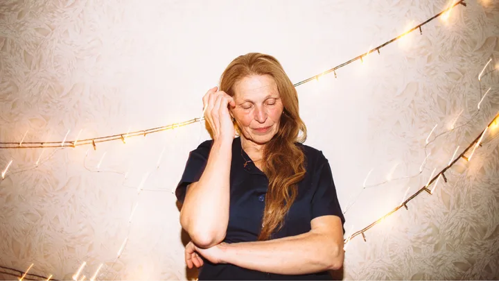 older woman touching hair