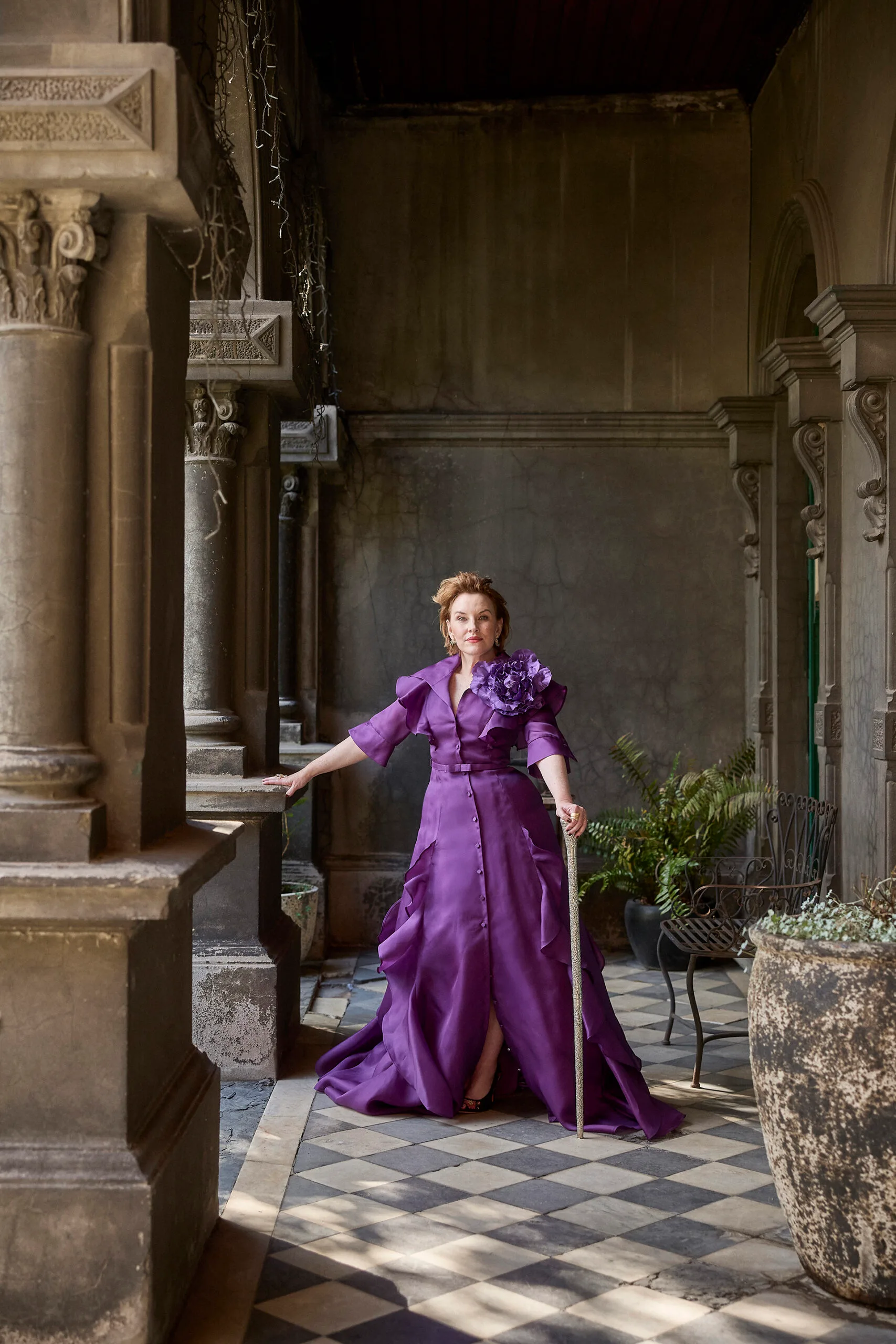 Kate Mulvany wearing a purple dress and using a cane. Photography by Peter Brew-Bevan