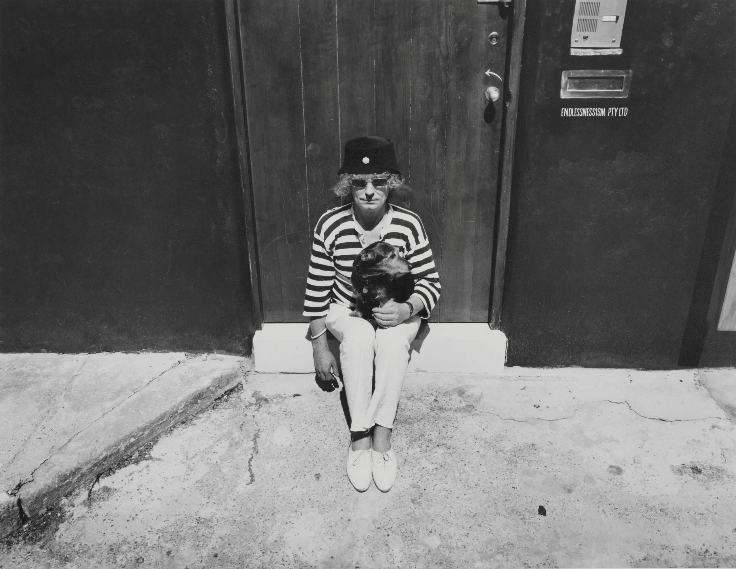 Brett Whiteley with pet terrier Sense at his Raper Street studio, Surry Hills, 1988, photo &copy; Estate of Jon Lewis