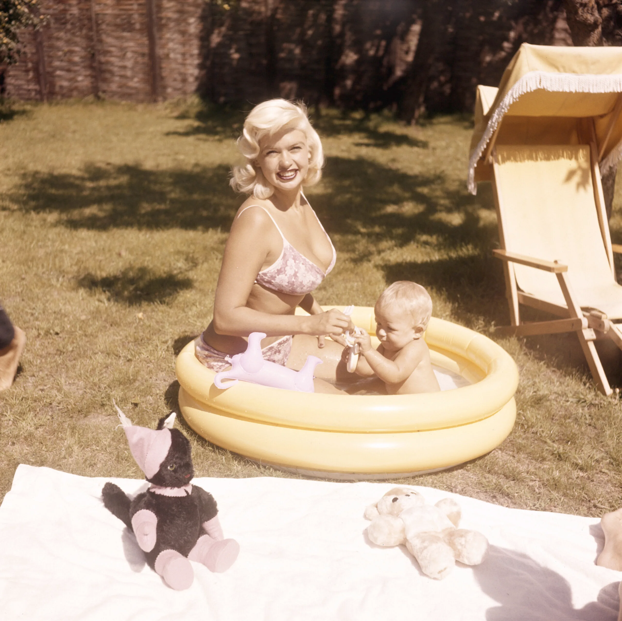 Jayne Mansfield (1933 - 1967) in the garden with her baby son Miklos, circa 1959. (Photo by Keystone/Hulton Archive/Getty Images)