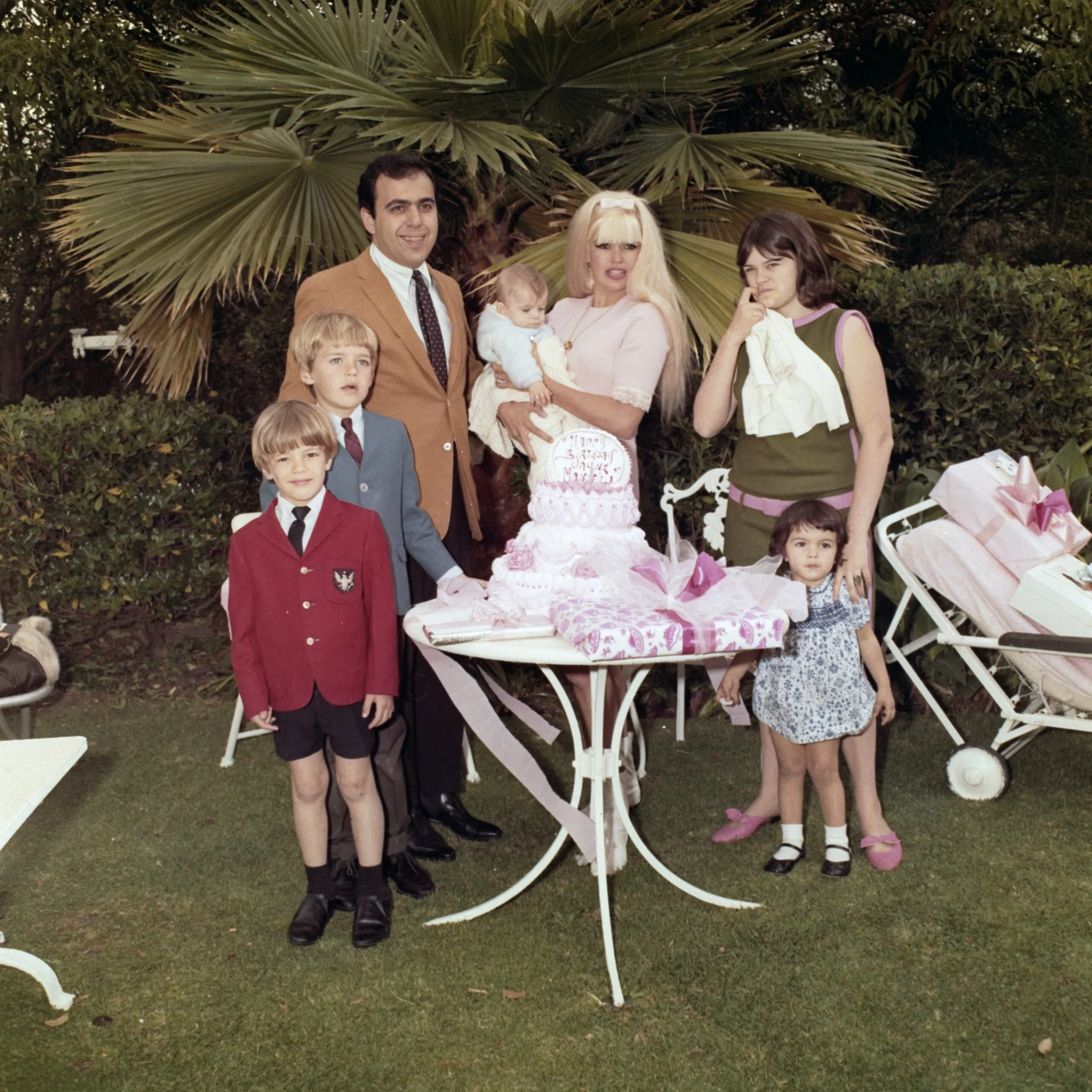 Jayne Mansfield And Family
American actress Jayne Mansfield (1933 - 1967) celebrating her 34th birthday with her family on the set of 'Single Room, Furnished' in Hollywood, California, April 1967. At left is Mansfield's third husband, Matt Cimber. Mansfield holds their one-year-old son Antonio. At right is her daughter Jayne Marie Mansfield, 16. Also present are her children by her second husband, Mickey Hargitay: Zoltan, 6, Miklos, 8, and Mariska, 3. 'Single Room, Furnished' was Mansfield's last film. (Photo by UPI/Bettmann Archive/Getty Images