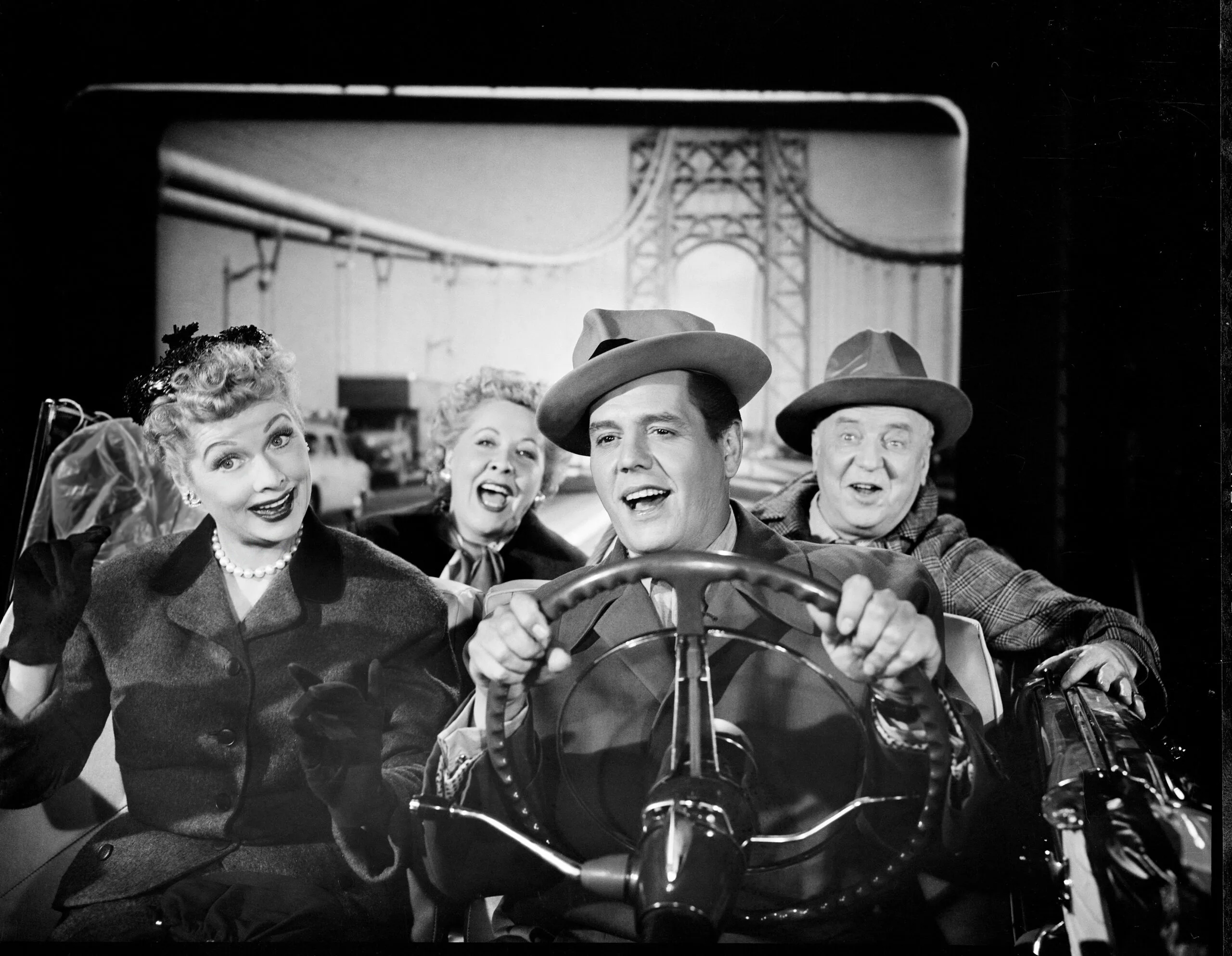 The cast of 'I Love Lucy' sits in a convertible with a backdrop of a suspension bridge behind them in an episode titled 'California, Here We Come!' Los Angeles, California, November 4, 1954. From left are American actress Lucille Ball (1911 - 1989) (as Lucy Ricardo), American actress Vivian Vance (1909 - 1979) (as Ethel Mertz), Cuban actor Desi Arnaz (1917 - 1986) (as Ricky Ricardo), and American actor William Frawley (1887 - 1966) (as Fred Mertz). The episode was originally broadcast on January 10, 1955. (Photo by CBS Photo Archive/Getty Images)