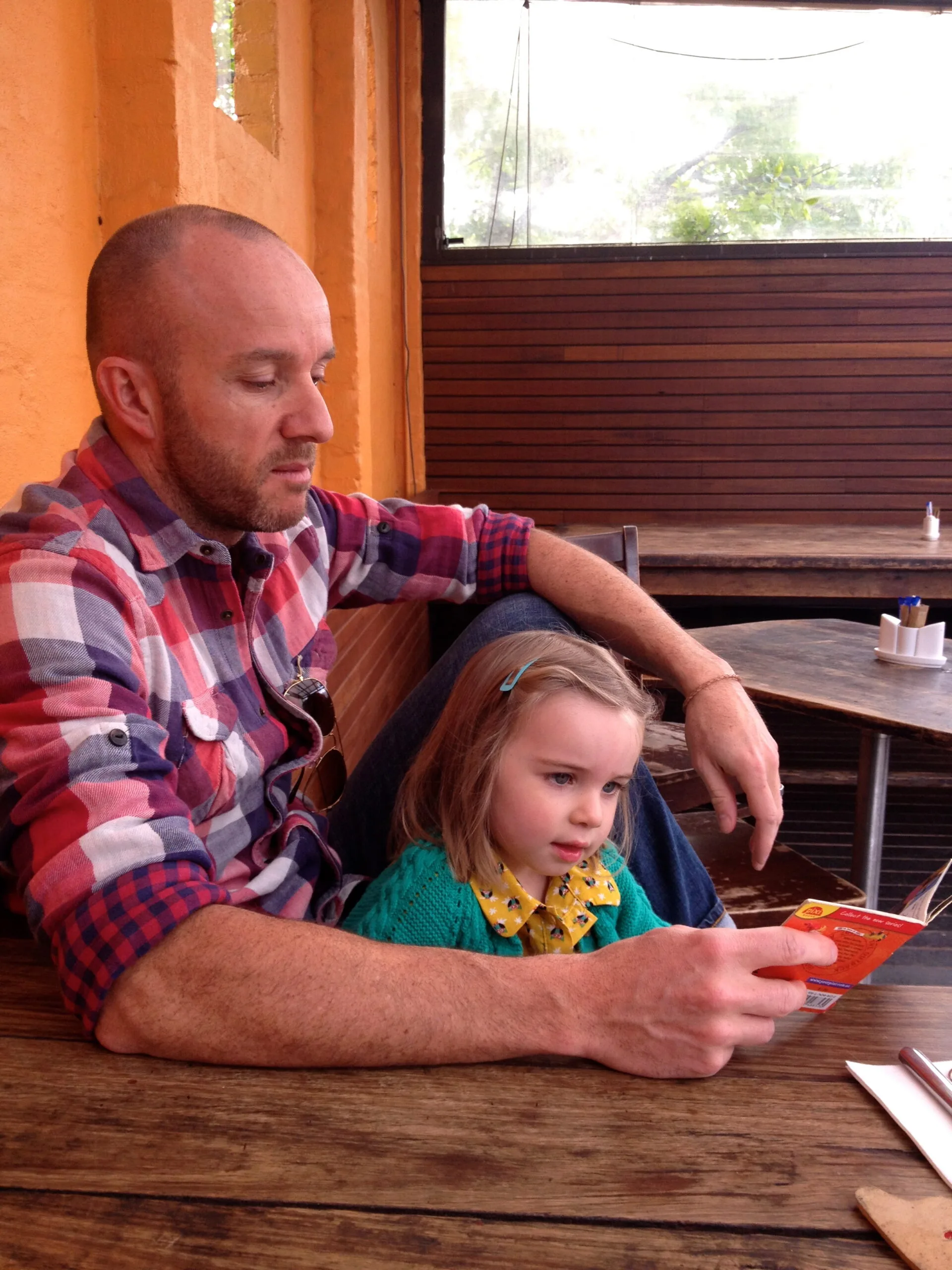 
Matt reading with his young daughter. Photo supplied and used with permission.