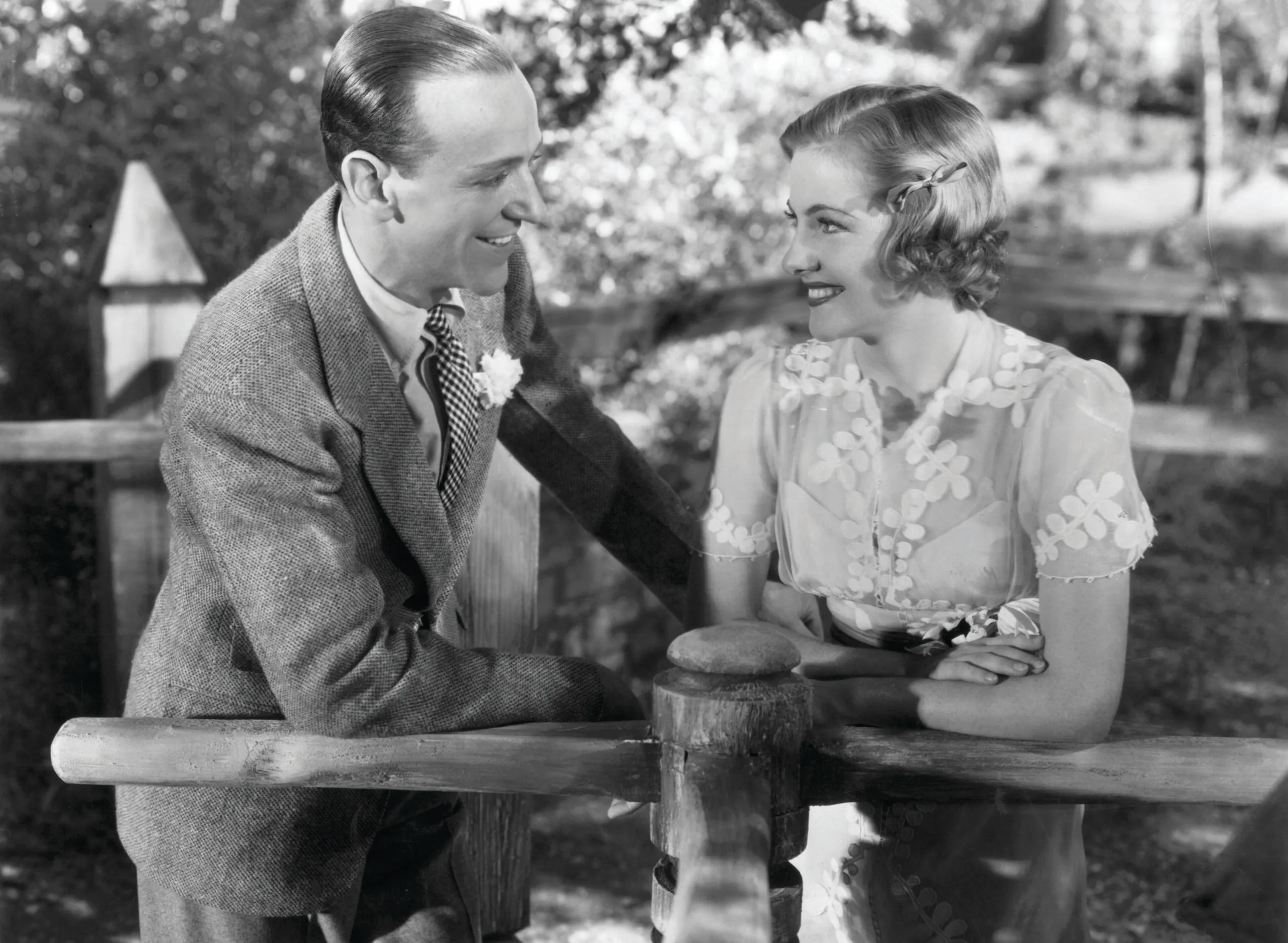 Fred Astaire and Joan Fontaine smiling at each other in a scene from the film 'Damsel In Distress', 1937. (Photo by RKO Radio Pictures/Getty Images)