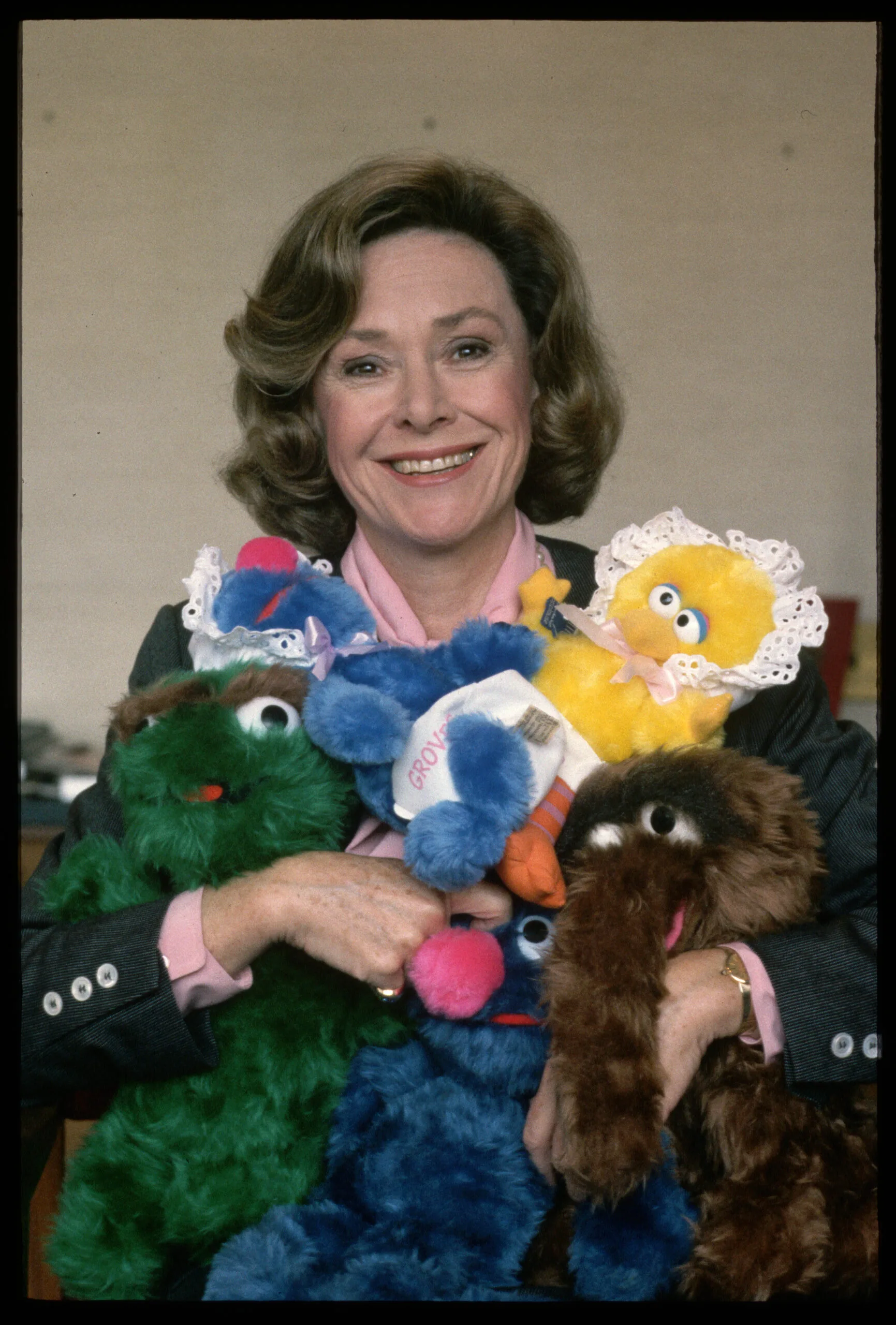 Joan Ganz Cooney, founder of The Children's Television Workshop, clutches Sesame Street stuffed animals. (Photo by Owen Franken/Corbis via Getty Images)