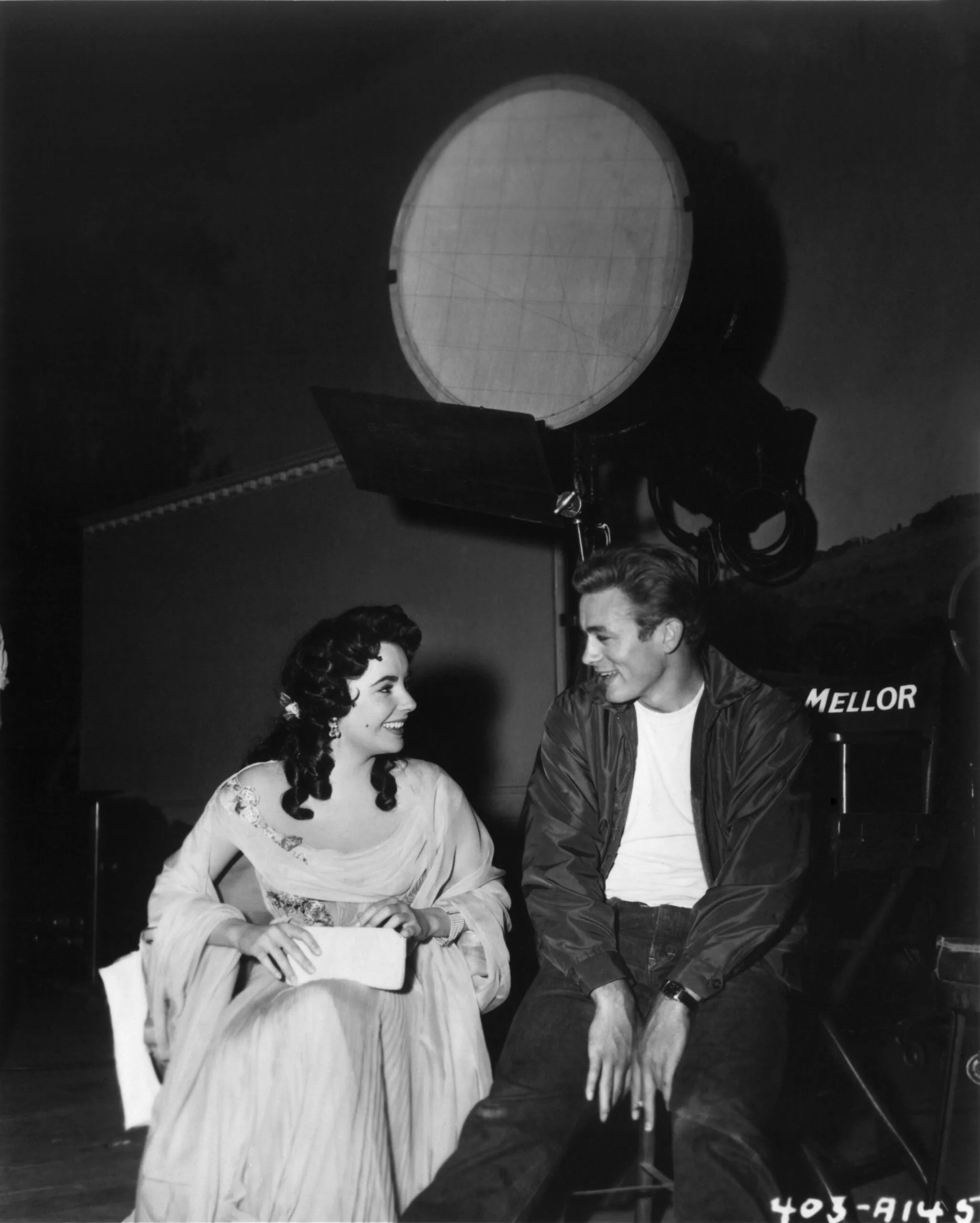 LOS ANGELES - 1955: Actors James Dean and Elizabeth Taylor chat on the set of the Warner Bros film 'Giant' in 1955 in Los Angeles, California. Dean has on the jacket he wore in his previous film "Rebel Without A Cause" (Photo by Michael Ochs Archives/Getty Images)